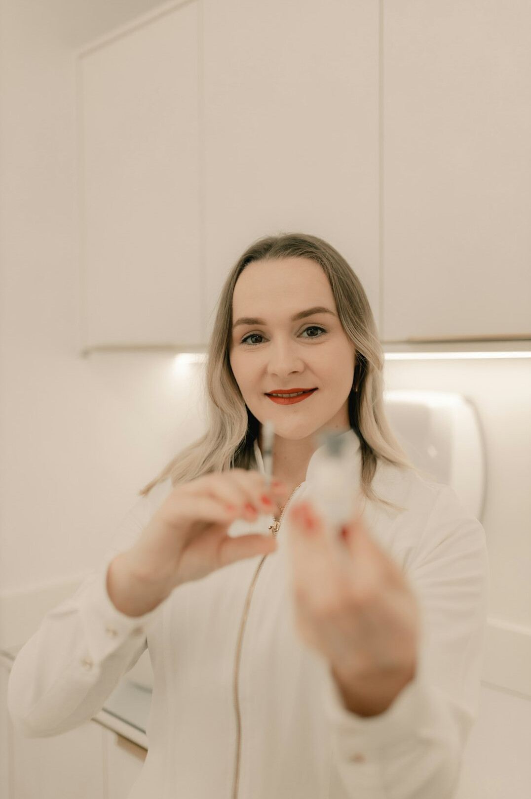 Smiling female nutritionist in a white coat